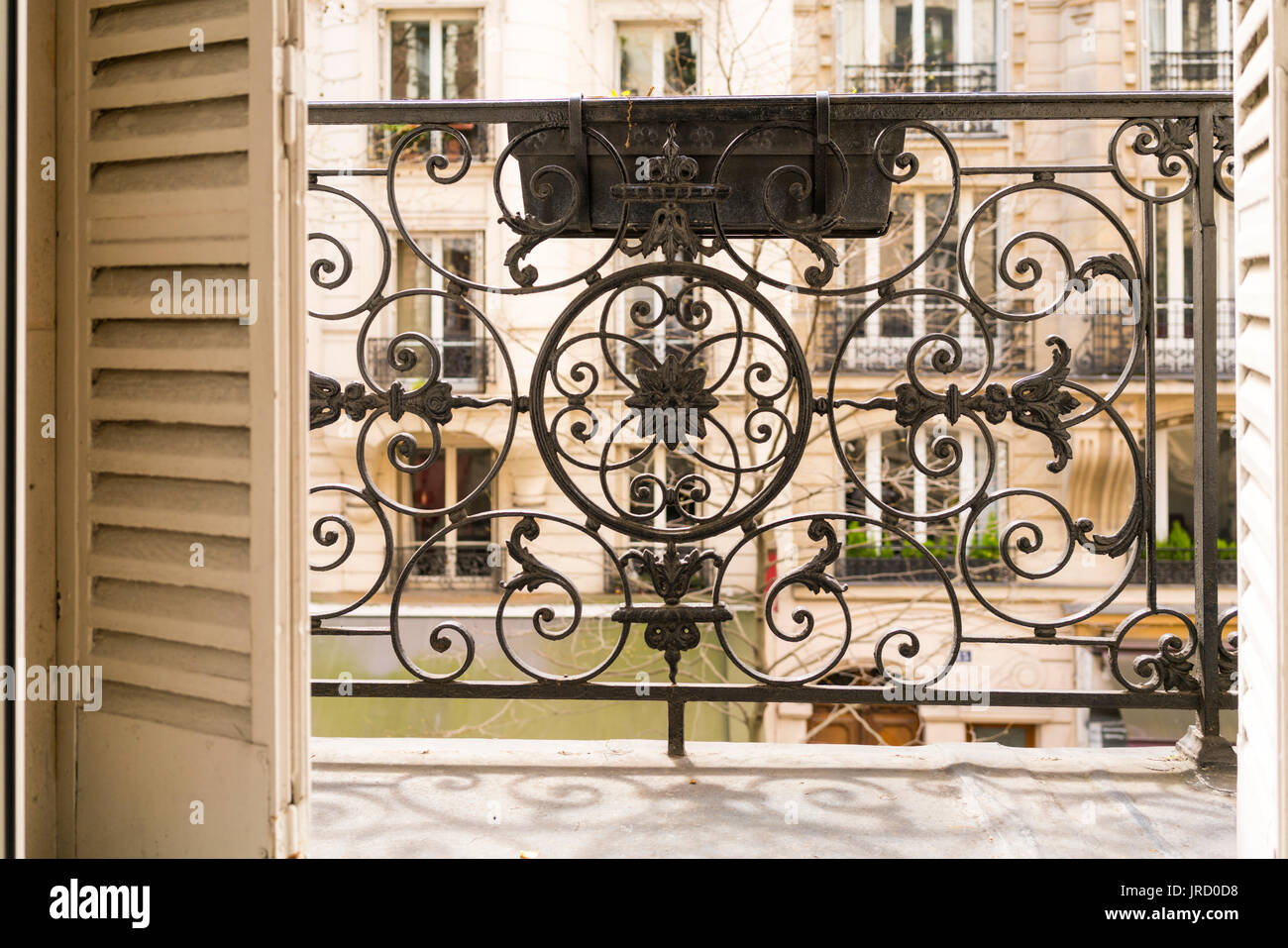 Balcony with decorative railing and shutters in Paris, France Stock Photo