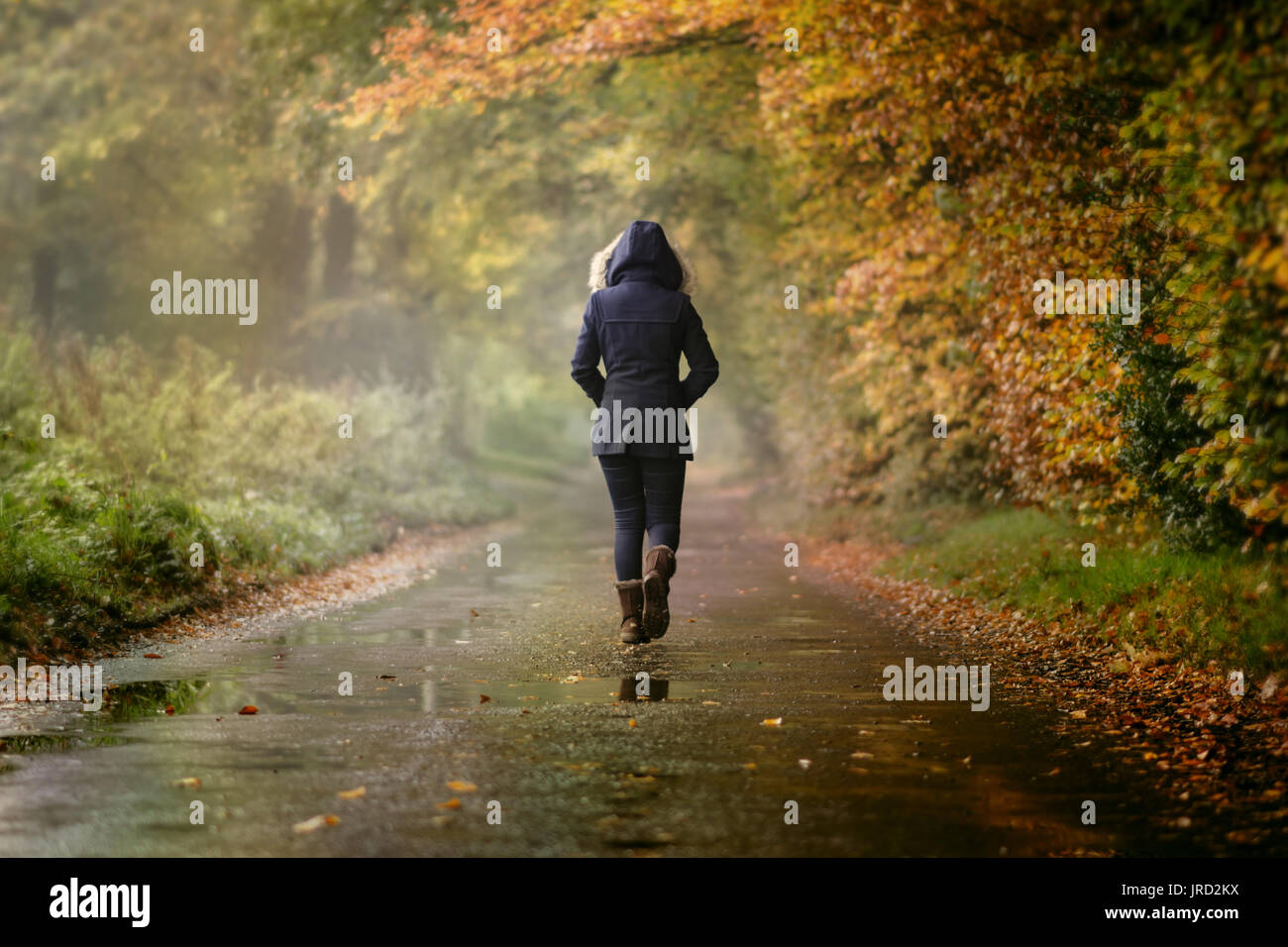 girl walking alone in rain