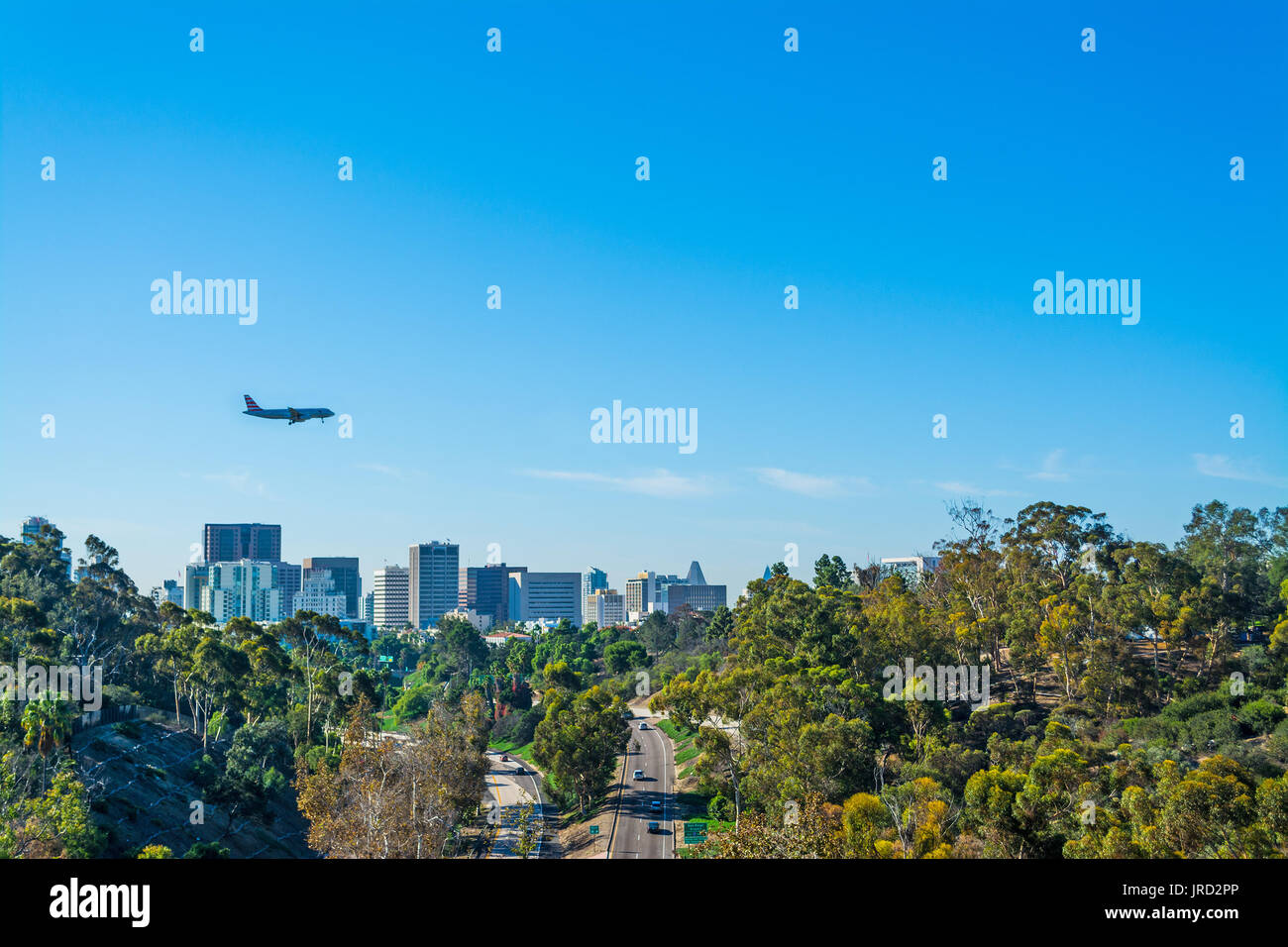 Airplane flying over high buildings hires stock photography and images