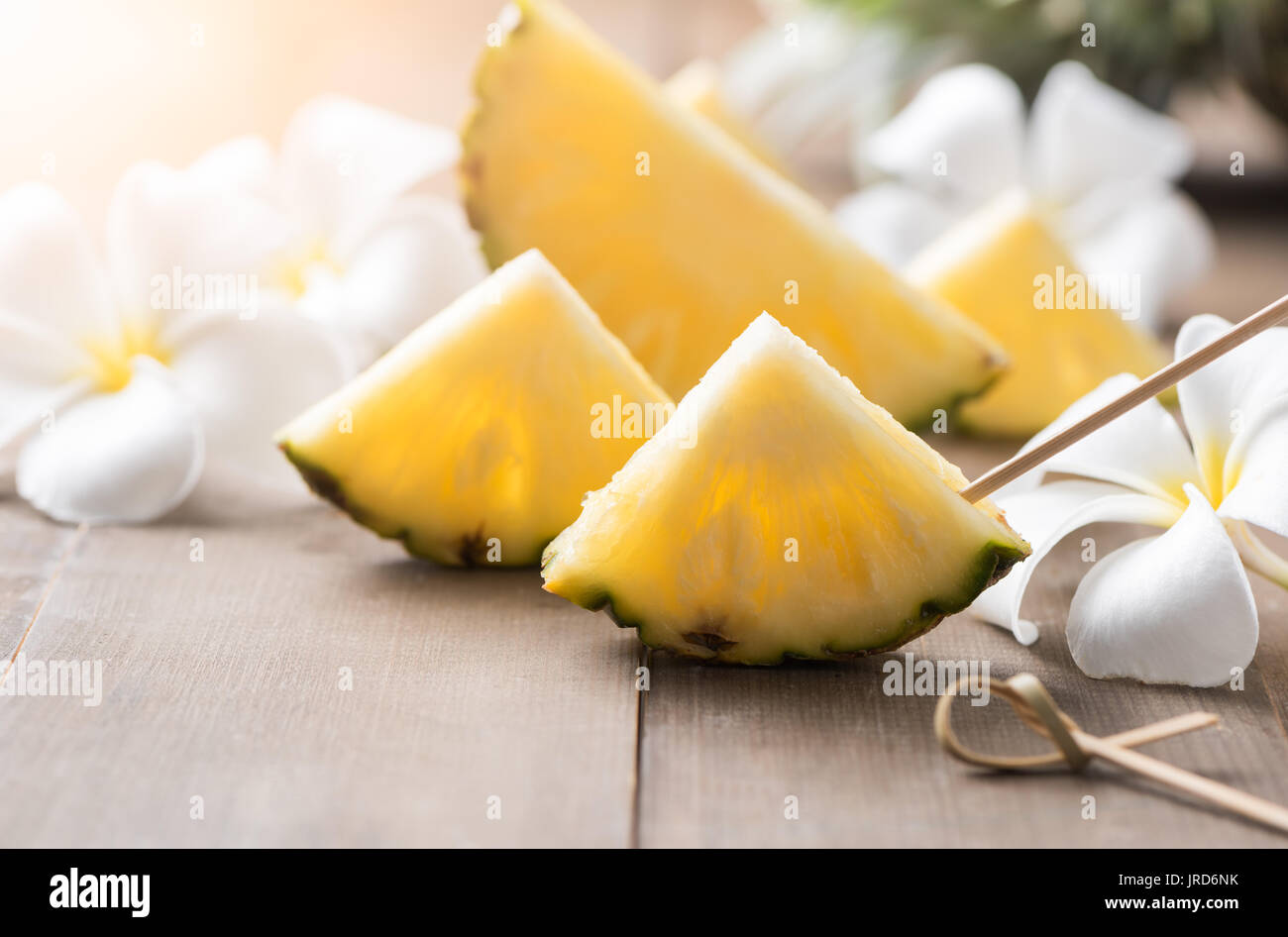 sliced pineapple on wood background, popular fruit in summer season Stock Photo