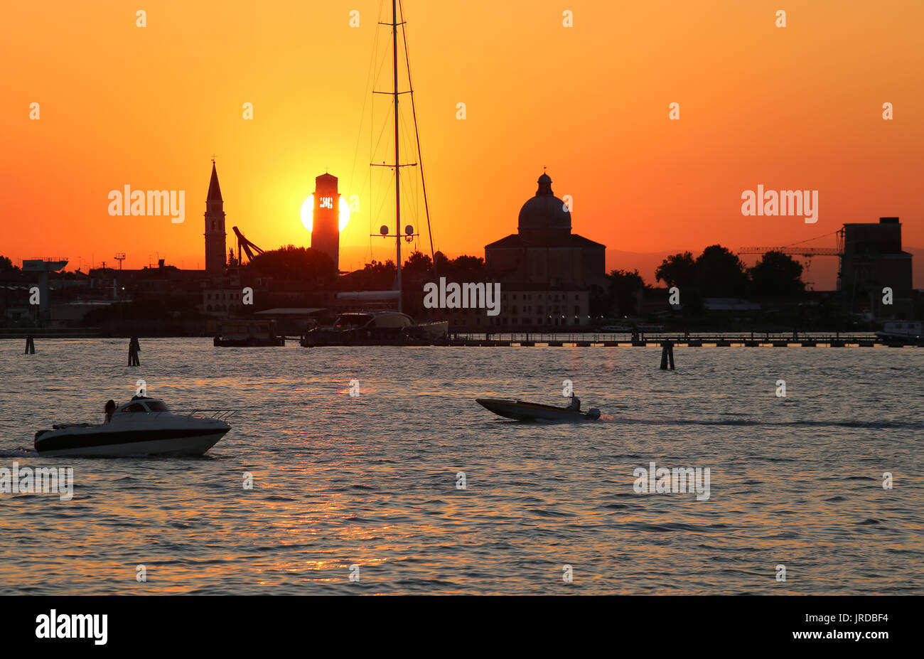 Great sun at sunset in VENICE in Italy and the shape of the churches ...