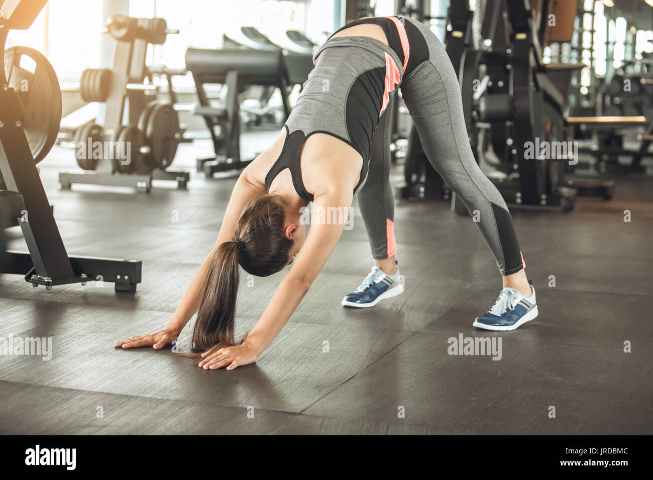 Young female exercise in the gym stretching Stock Photo