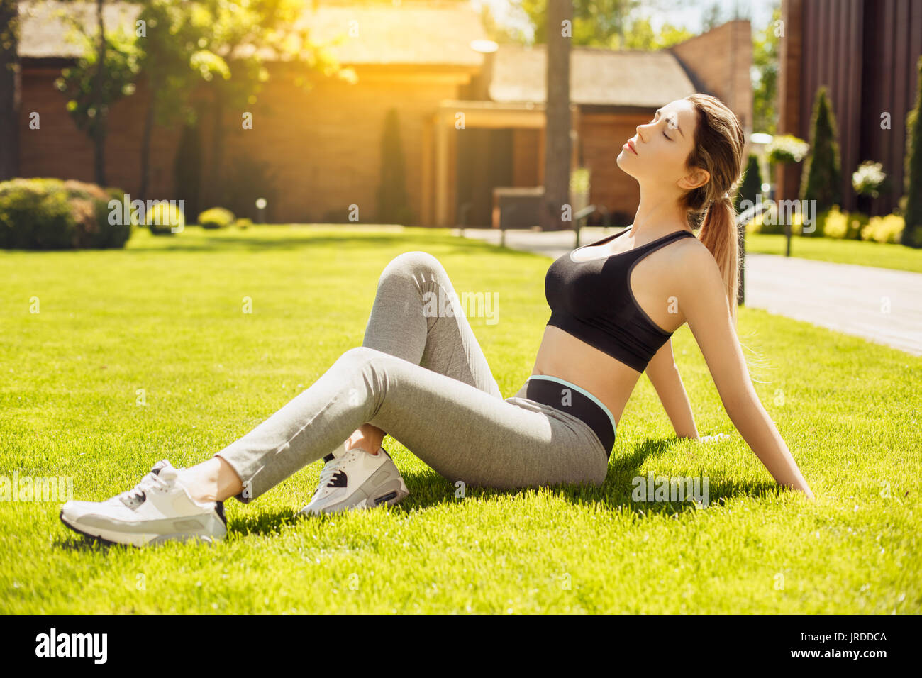 Young female exercise in the park relaxation Stock Photo