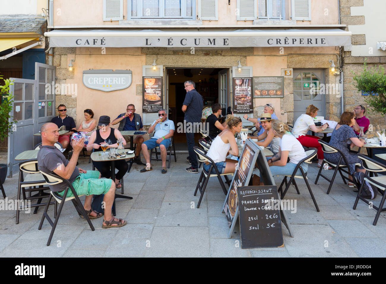 French cafe - people eating and drinking at a creperie or cafe, Concarneau, Brittany France Stock Photo