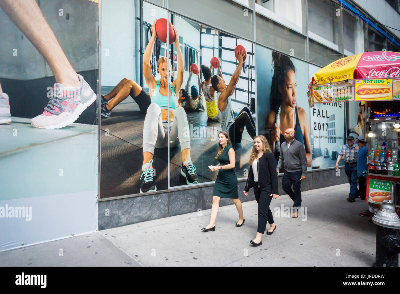 Colorful photographs decorate the under construction Asics store on Fifth Avenue in New York on Thursday, August 3, 2017. The stretch of Fifth Avenue in Midtown is becoming a 'Sneaker Row' as sneaker brands lease space to open flagship stores. Under Armour and Nike are working on stores besides Asics and Adidas has already opened an enormous space.  (© Richard B. Levine) Stock Photo