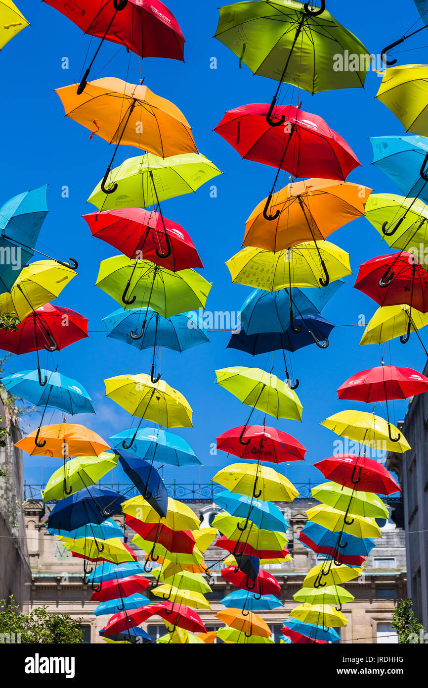 Two hundred colourful umbrellas sway in the summer breeze as they hang above a street in Liverpool city centre to raise awareness about ADHT. Stock Photo
