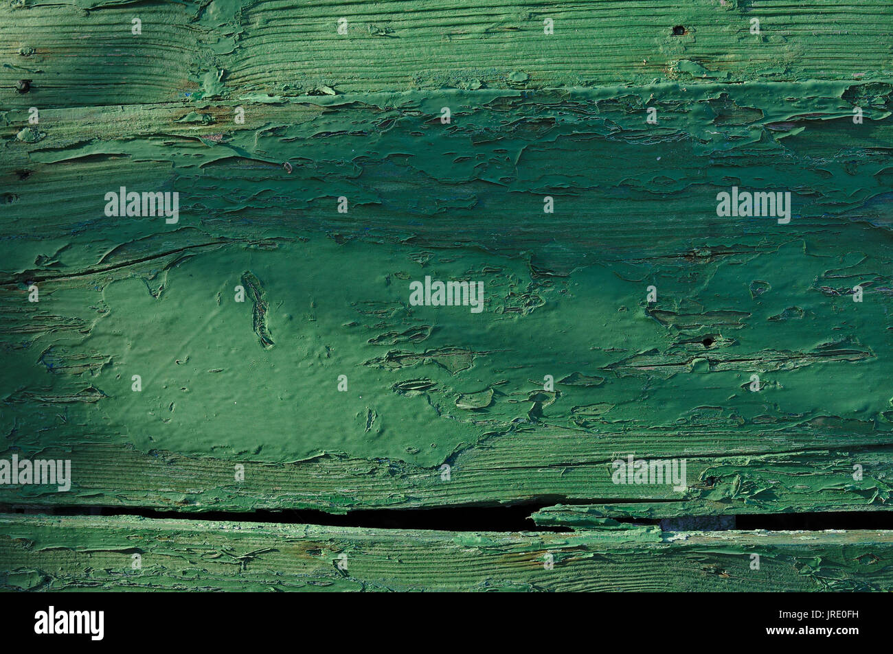 Green wooden texture with paint peeling out. Boat hull in Algarve, Portugal Stock Photo