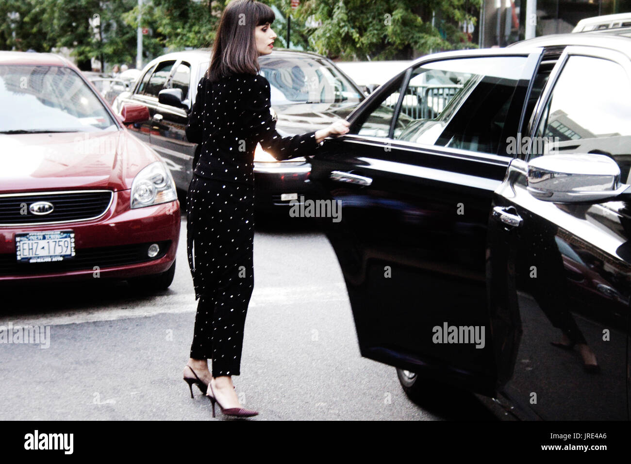Woman getting into a car legs hi-res stock photography and images - Alamy