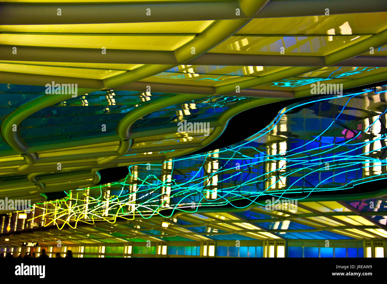 Brilliant neon lights illuminate the Chicago O'Hare airport walkway. Stock Photo