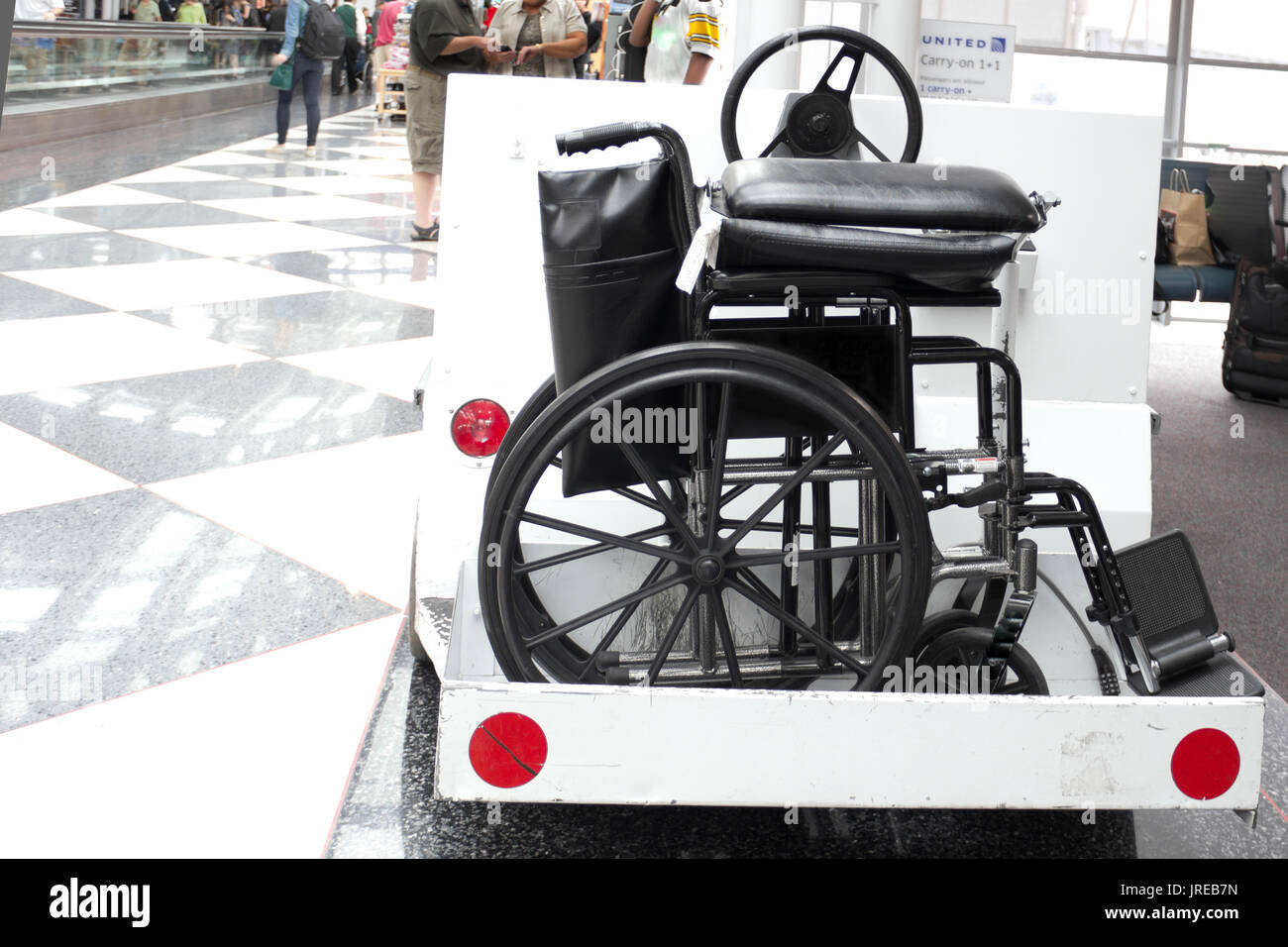 A wheelchair is carried on an airport cart by the Chicago O'Hare