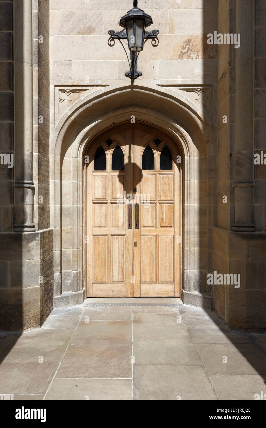 Stone door surround and double doors at West entrance to all saints stand church whitefield bury uk Stock Photo