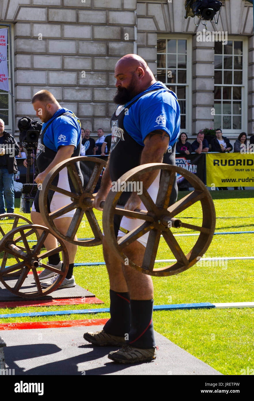 Competitors strain in the power lifting heat of the Ultimate Strongest Man competition that was held and televised in the grounds of the Belfast City Stock Photo