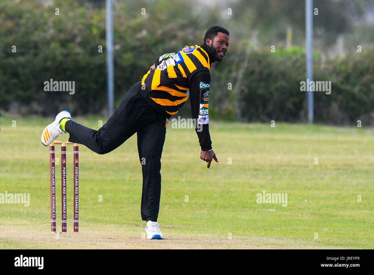 Easton, Portland, Dorset, UK.  4th August 2017.  West Indies Kirk Edwards bowling during the Portland Red Triangle match v Lashings All Stars at the Reforne cricket ground at Easton in Dorset.  Photo Credit: Graham Hunt/Alamy Live News Stock Photo