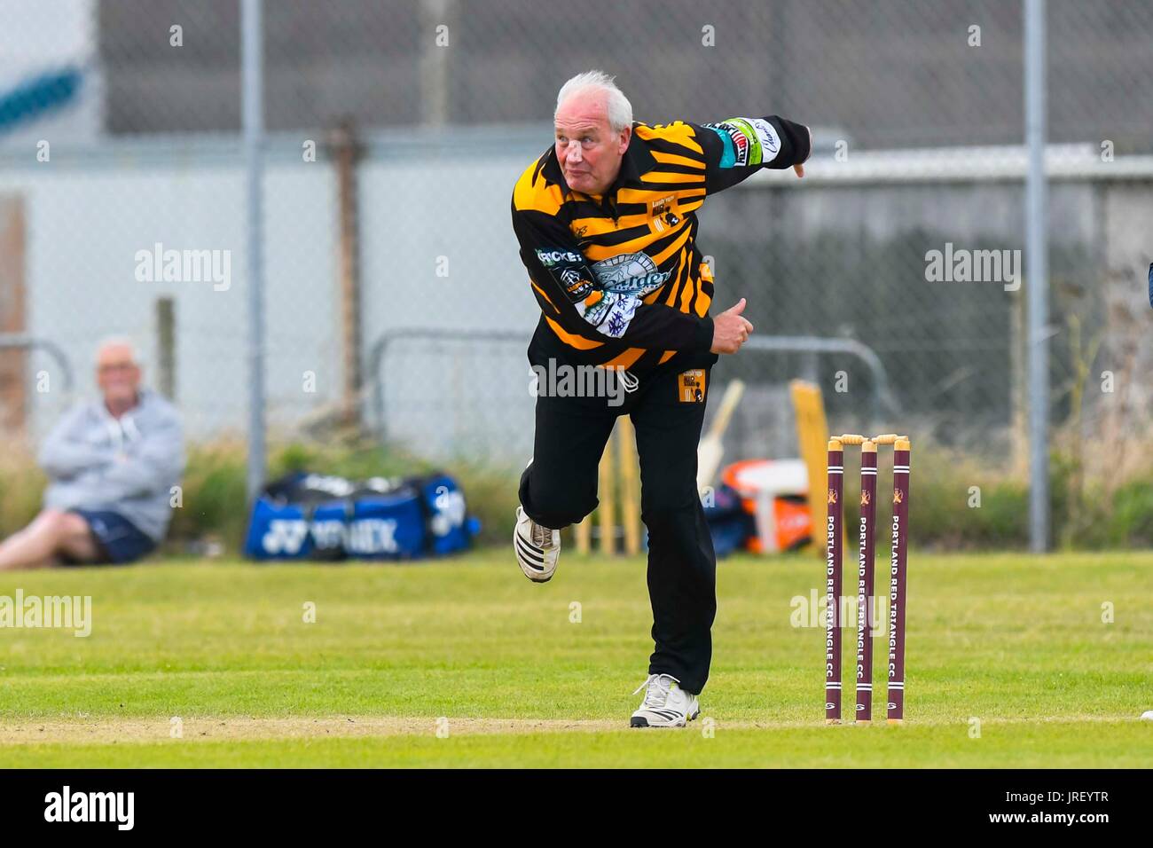 Easton, Portland, Dorset, UK.  4th August 2017.  Former England spin bowling legend John Embury during the Portland Red Triangle match v Lashings All Stars at the Reforne cricket ground at Easton in Dorset.  Photo Credit: Graham Hunt/Alamy Live News Stock Photo