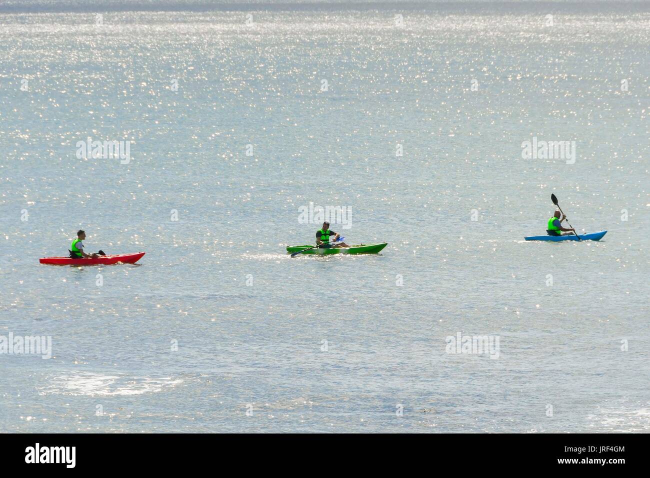 Lyme Regis, Dorset, UK.  5th August 2017.  UK Weather.  Holidaymakers with kayaks enjoying the morning sunhine at the seaside resort of Lyme Regis in Dorset.  Photo Credit: Graham Hunt/Alamy Live News Stock Photo
