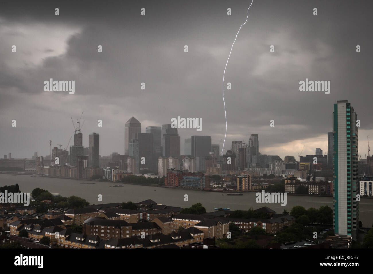 London, UK. 5th Aug, 2017. UK Weather: Afternoon lightning strike over Canary Wharf business park buildings in east London. Credit: Guy Corbishley/Alamy Live News Stock Photo