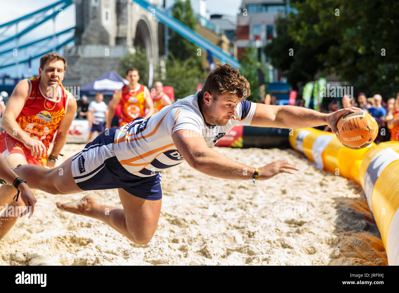 City Hall, London, UK, 5th August 2017. A Player from Doom Platoon dives with the ball. Tourists and Londoners watch as a total of 20 teams compete in Saturday's London Beach Rugby, now held in its 5th year. The event is free to spectators. London Beach Rugby is a 5 a side touch rugby tournament. Credit: Imageplotter News and Sports/Alamy Live News Stock Photo