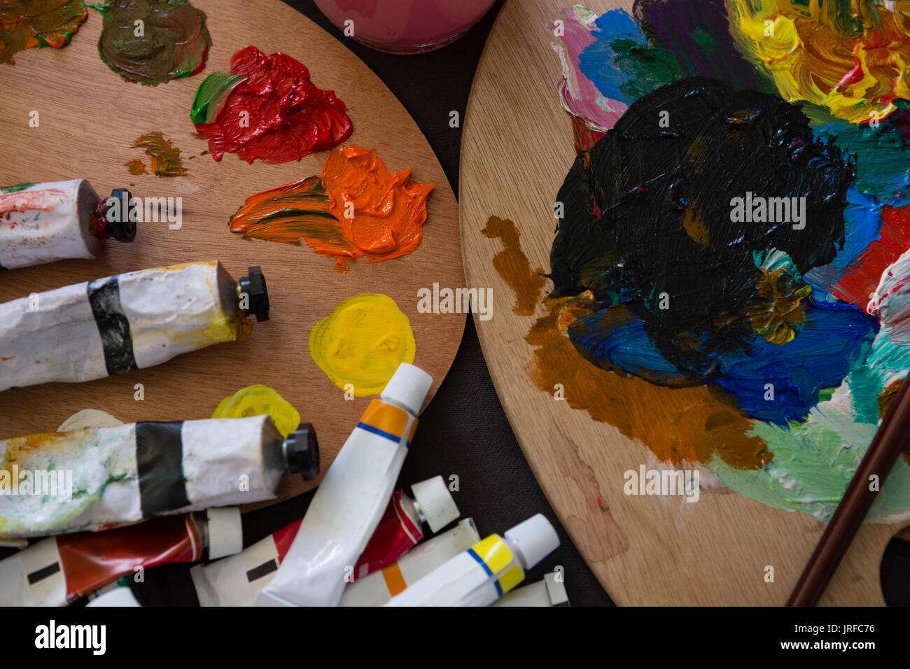 High angle view of tubes on color palette in art class Stock Photo