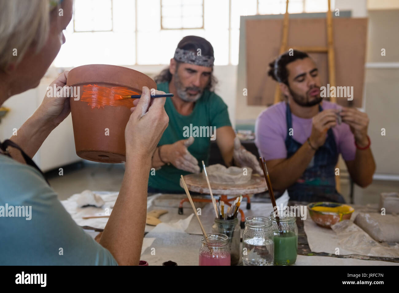 Adult students sittng at table in art class Stock Photo