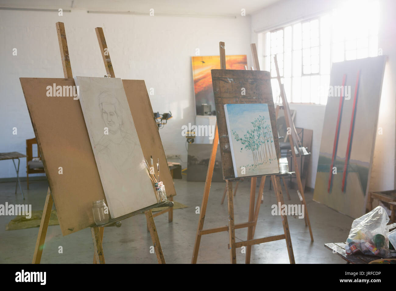 Paintings on easel in art studio Stock Photo Alamy