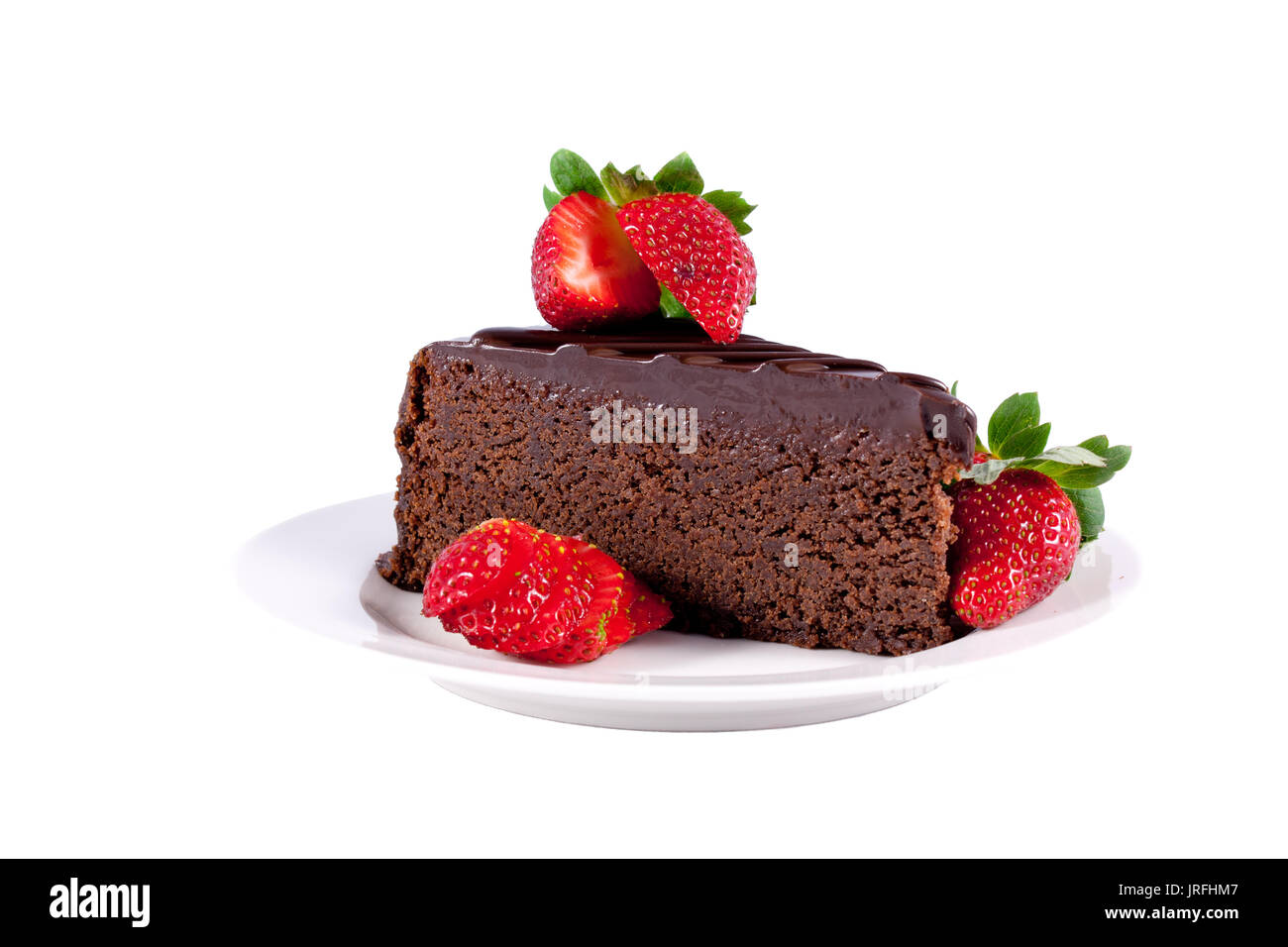Slice of chocolate celebration cake with fresh strawberries isolated on ...