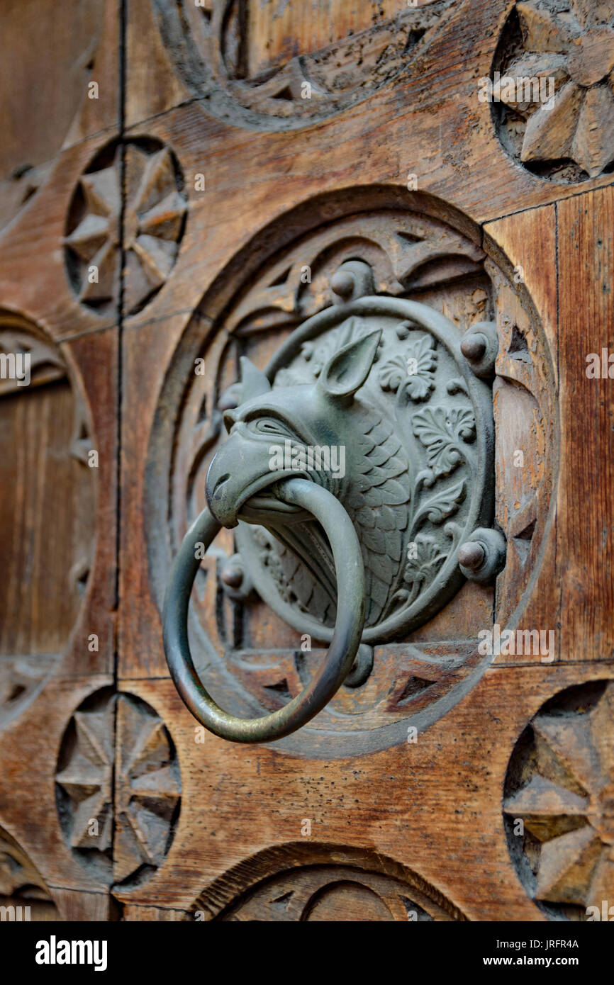 Antique door knocker shaped like monster's head. Stock Photo
