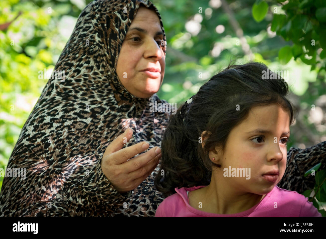 Palestinian mother & daughter describe their interactions with their Israeli settler neighbors in the center of Hebron in the Occupied Territories Stock Photo