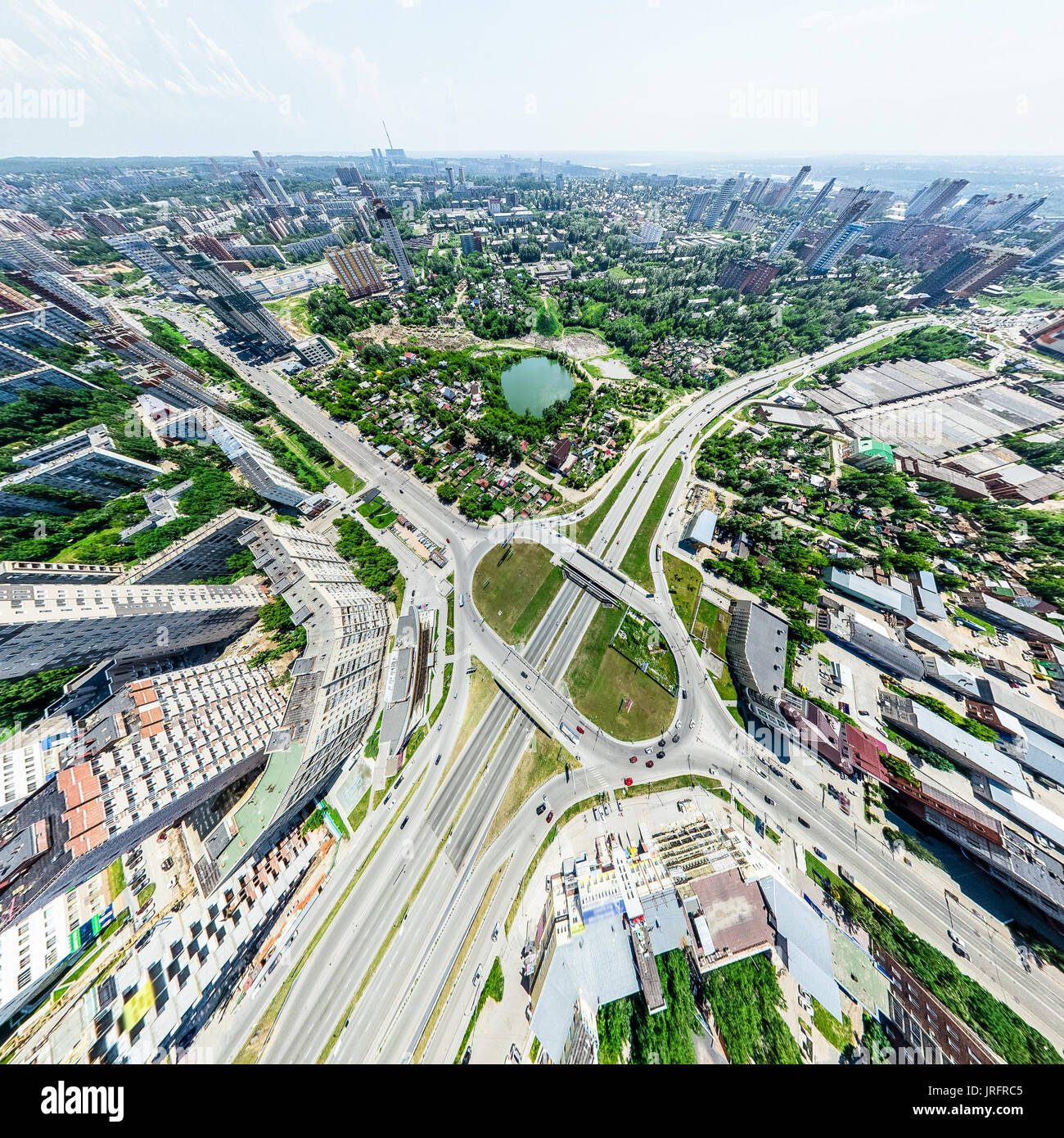 Aerial city view with crossroads and roads, houses, buildings, parks ...