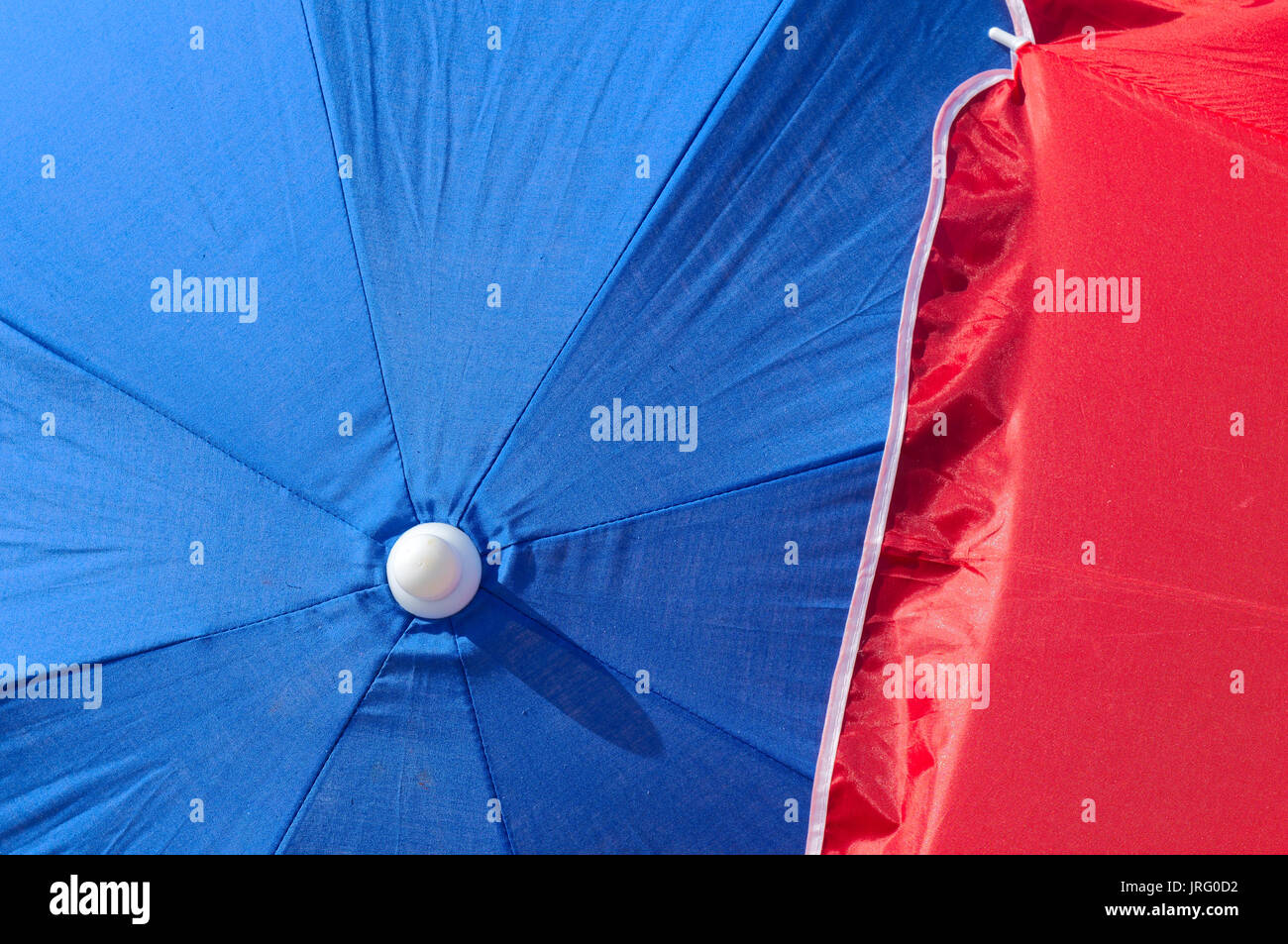 Blue and red Beach umbrella. Summertime and vacations theme Stock Photo