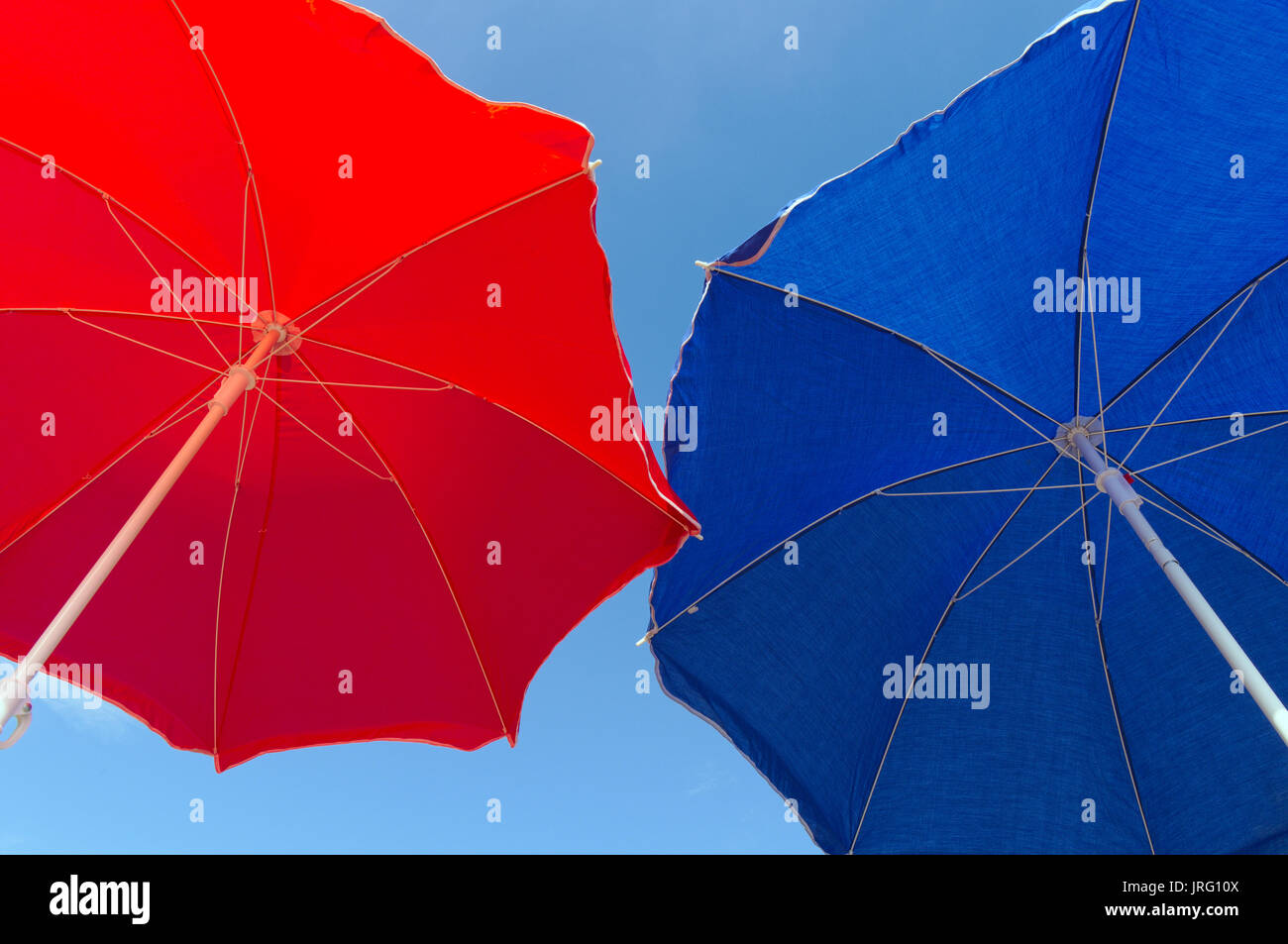 Blue and red Beach umbrella. Summertime and vacations theme Stock Photo