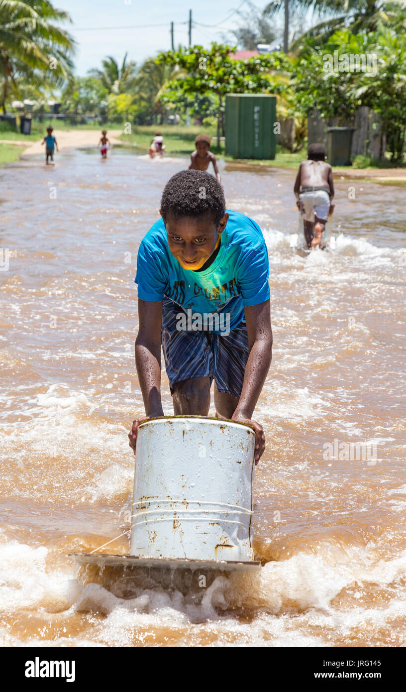 Torres Strait island children play in king tides off lowlying Saibai