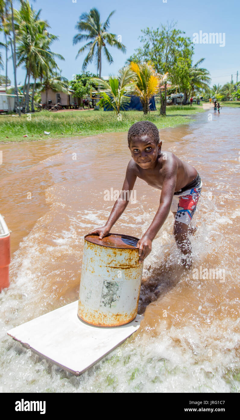 Torres Strait island children play in king tides off low-lying Saibai island Stock Photo