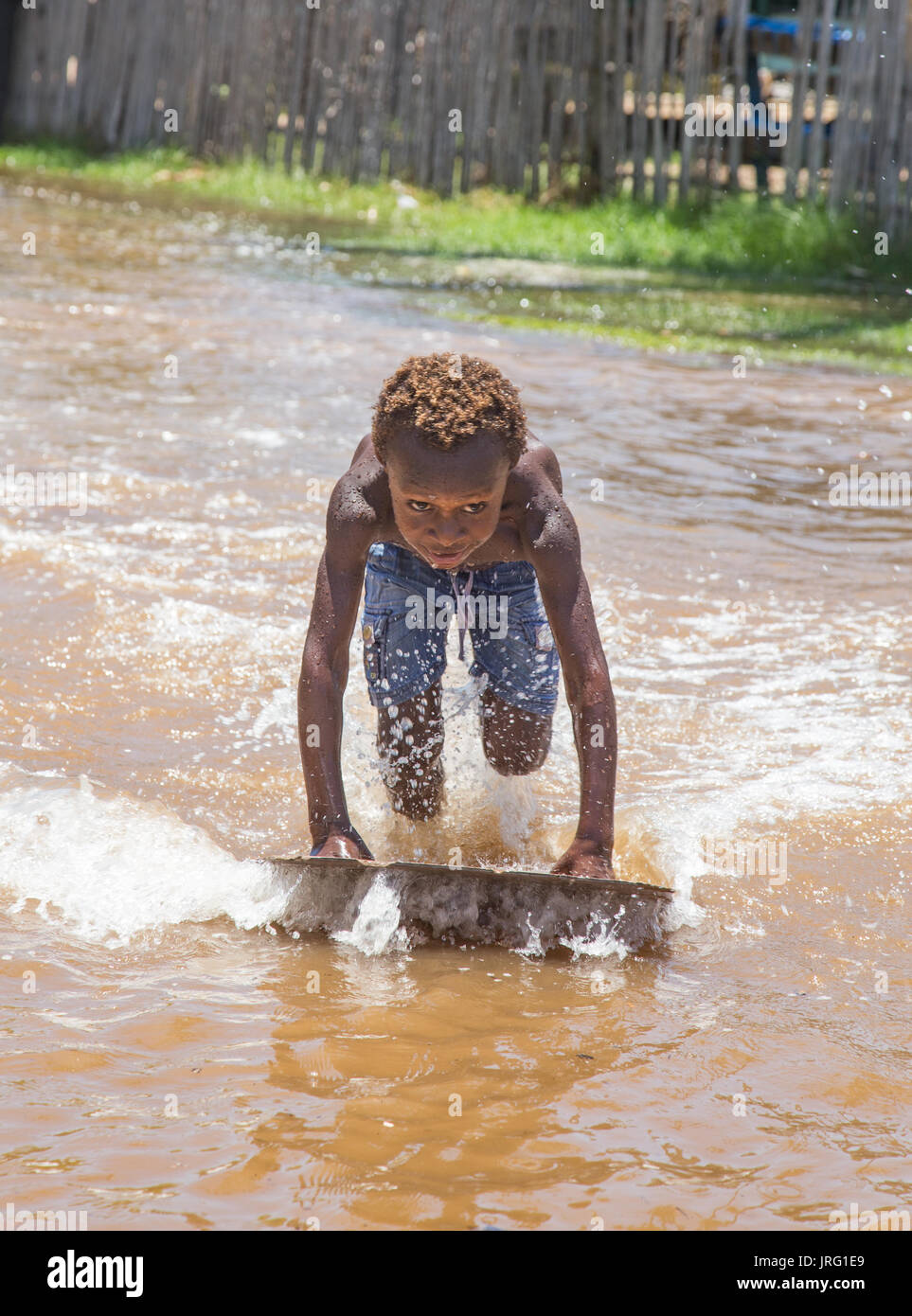 Torres Strait island children play in king tides off low-lying Saibai island Stock Photo