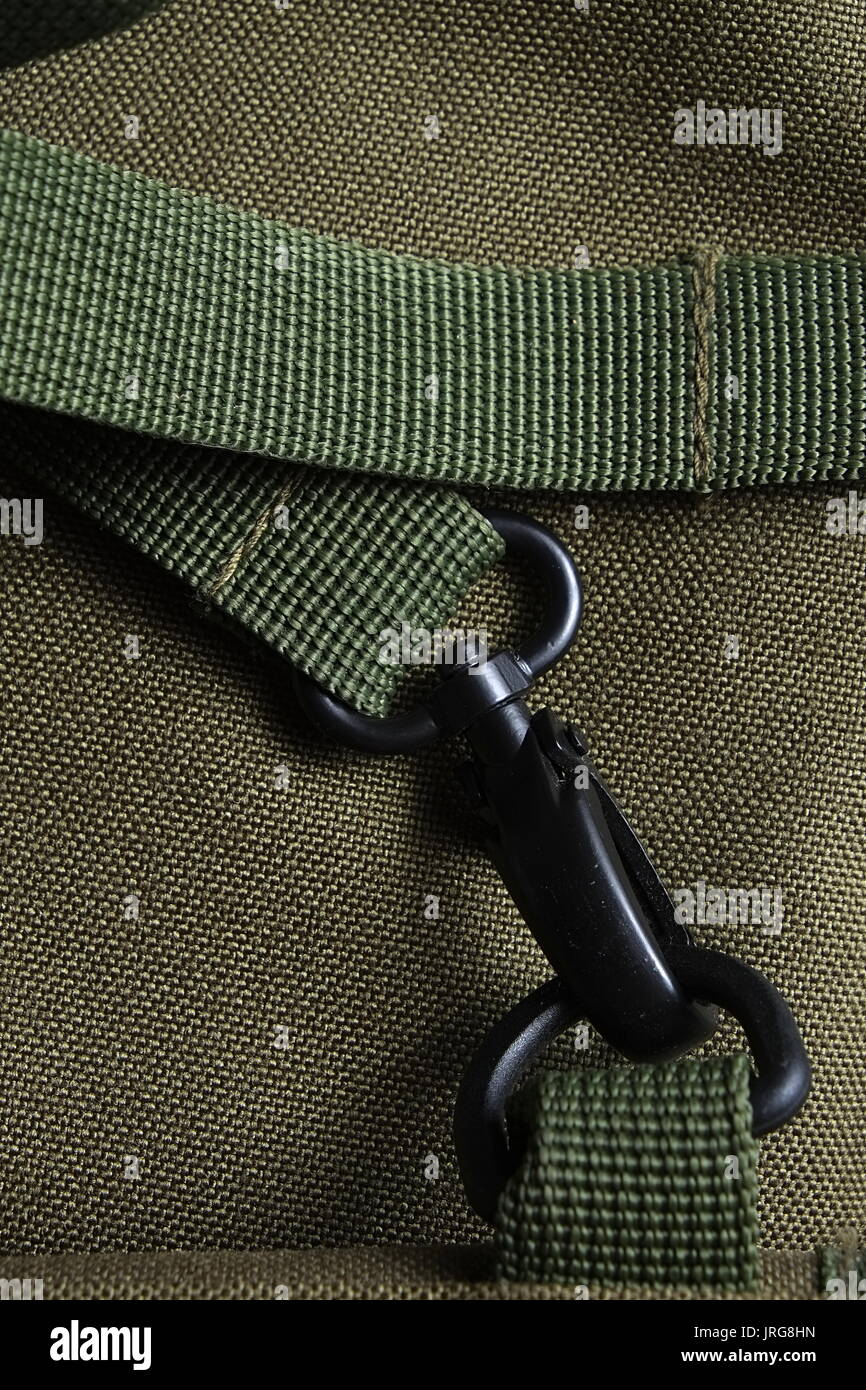 Detail of a tactical holdall army bag, showing canvas and a strong black metal clasp Stock Photo