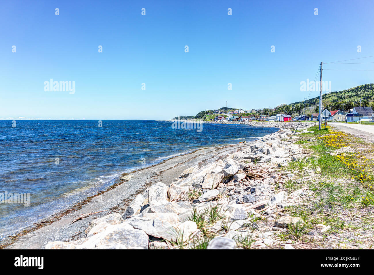 Cityscape of GrossesRoches village town and SaintLawrence river during day with colorful