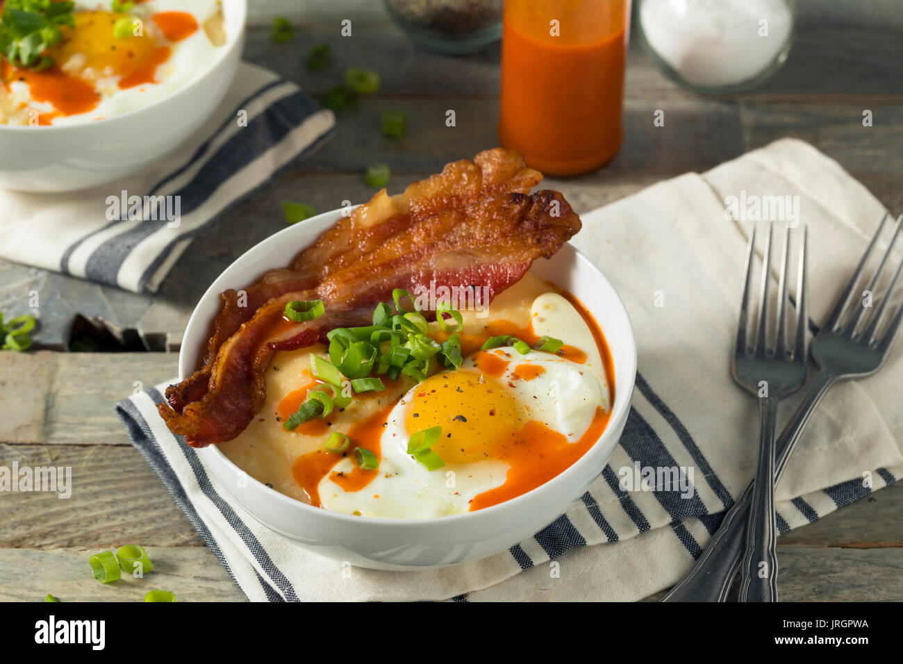 Homemade Cheesy Breakfast Grits with Eggs and Bacon Stock Photo Alamy