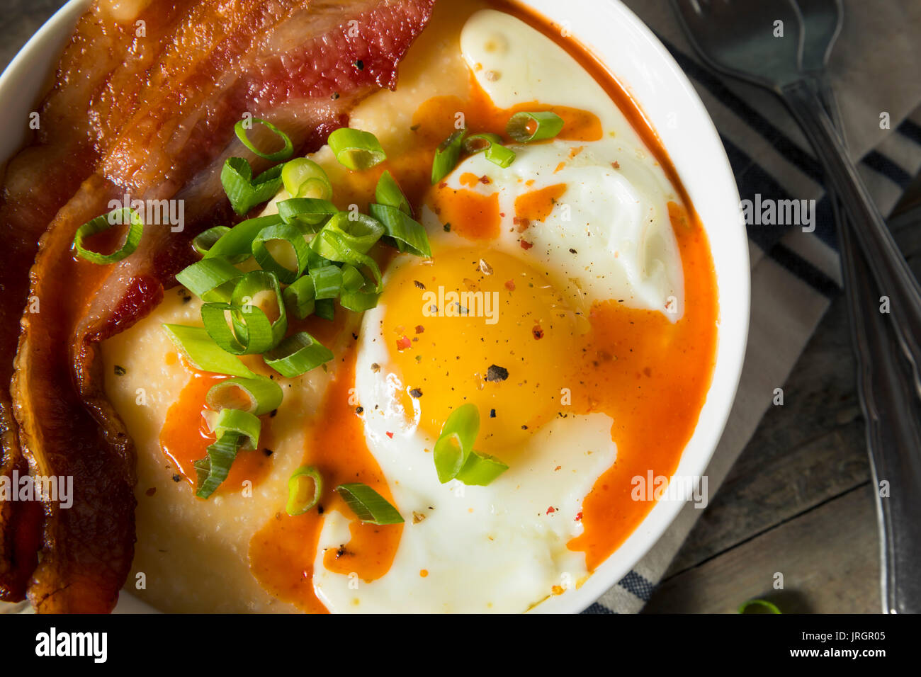 Homemade Cheesy Breakfast Grits with Eggs and Bacon Stock Photo Alamy