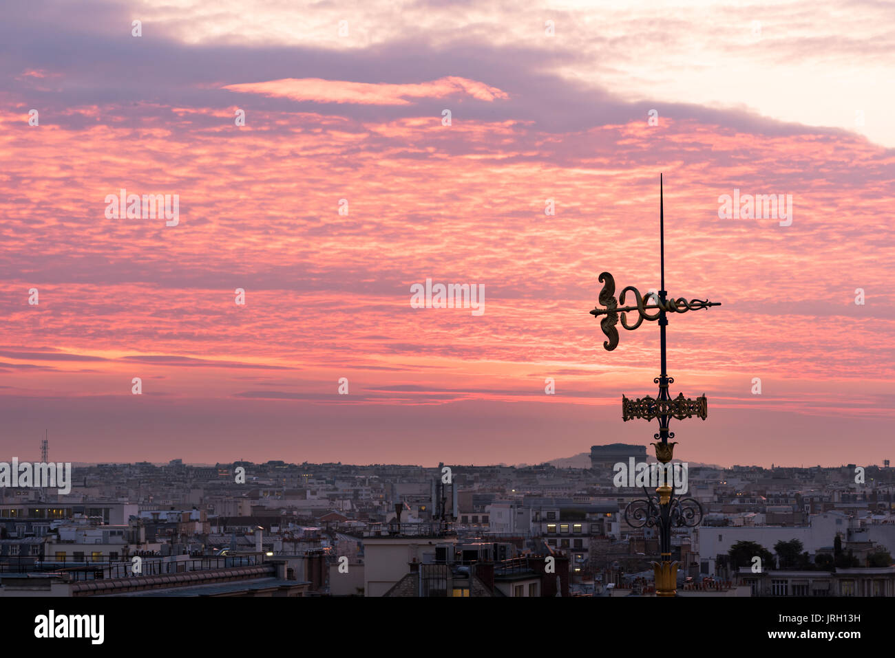 Decorative antenna against purple colored clouds in Paris Stock Photo