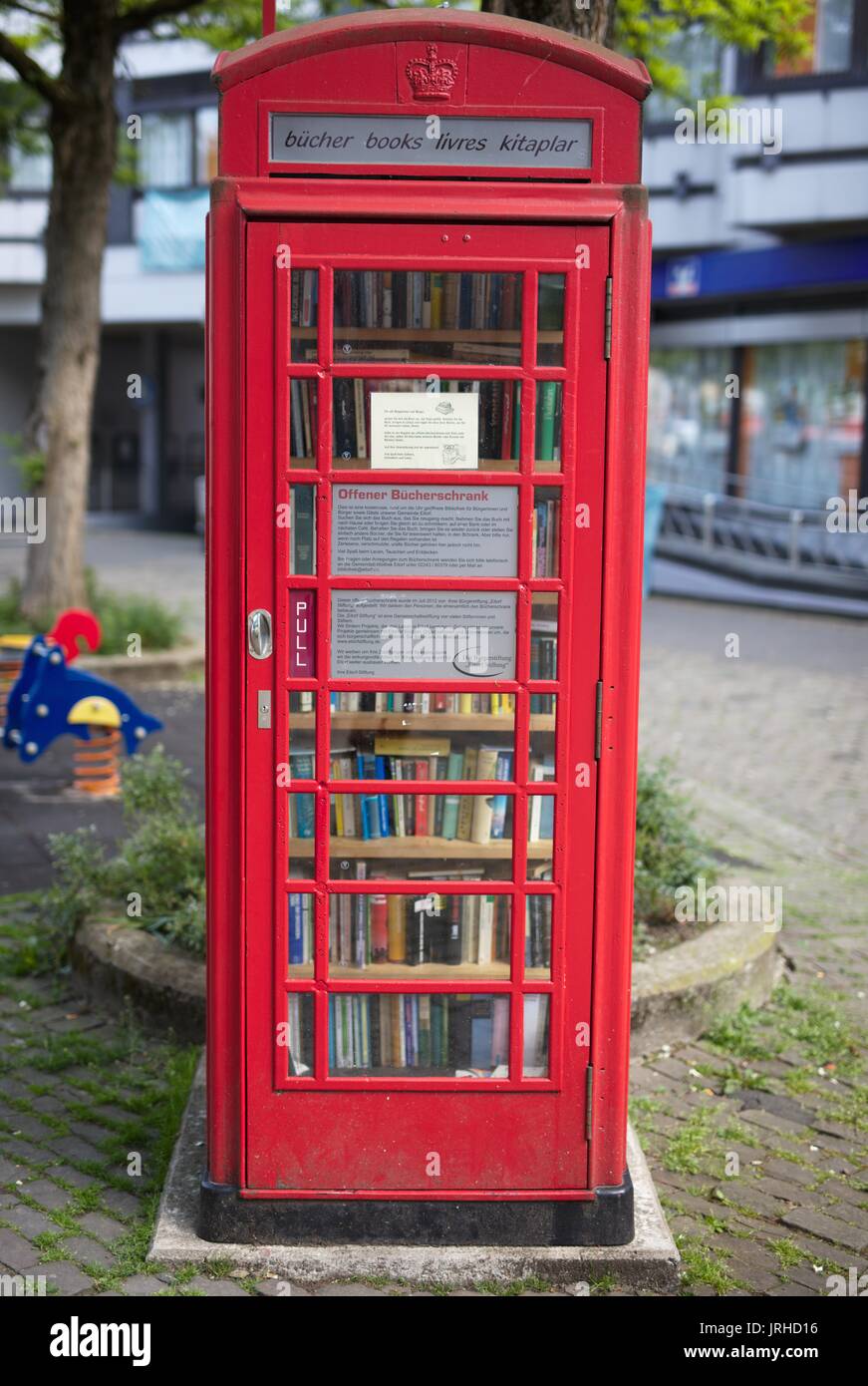Old British Telephone Booth converted into a public book shelve Stock Photo