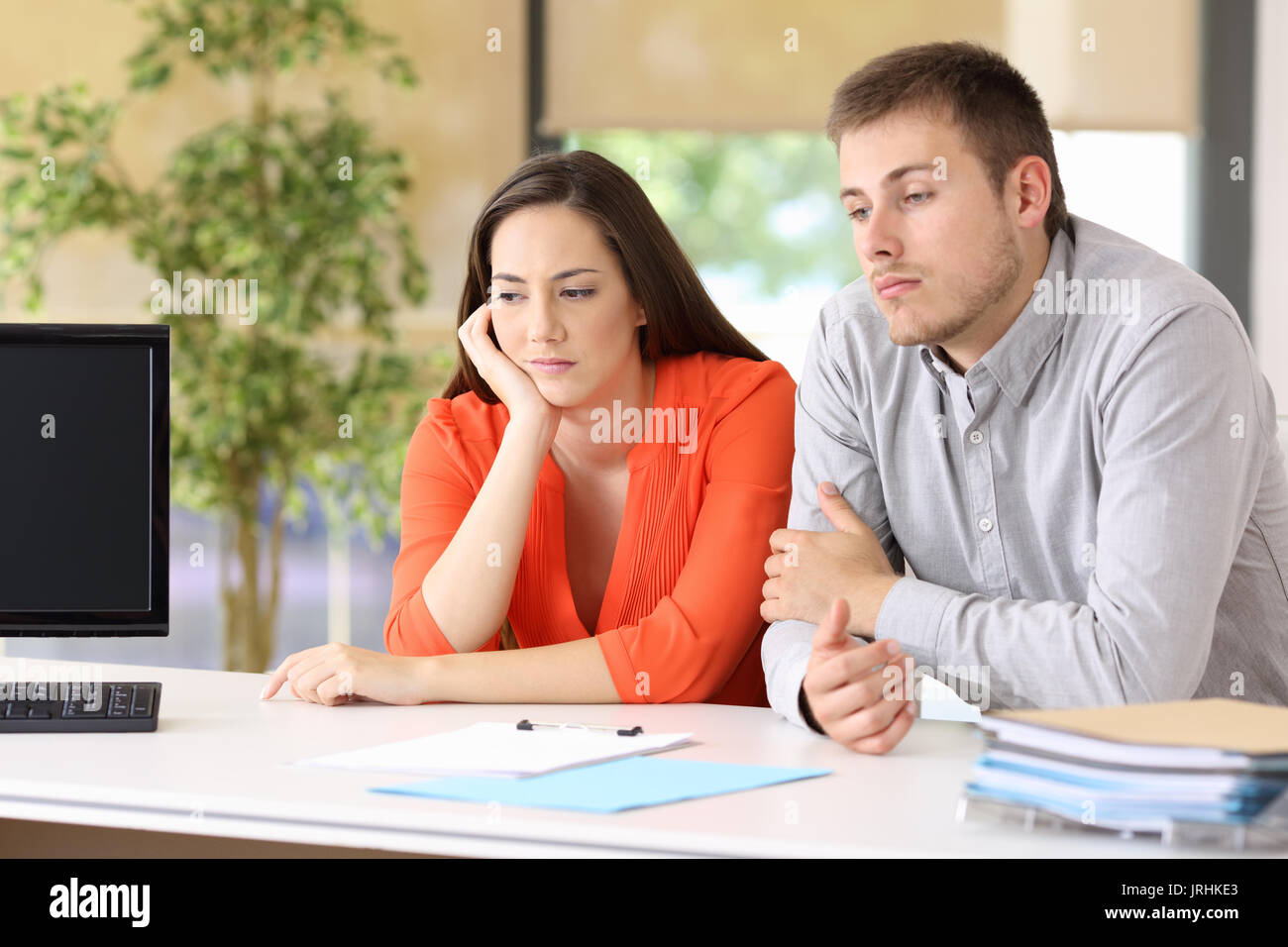Two bored customers waiting for attendance at office Stock Photo