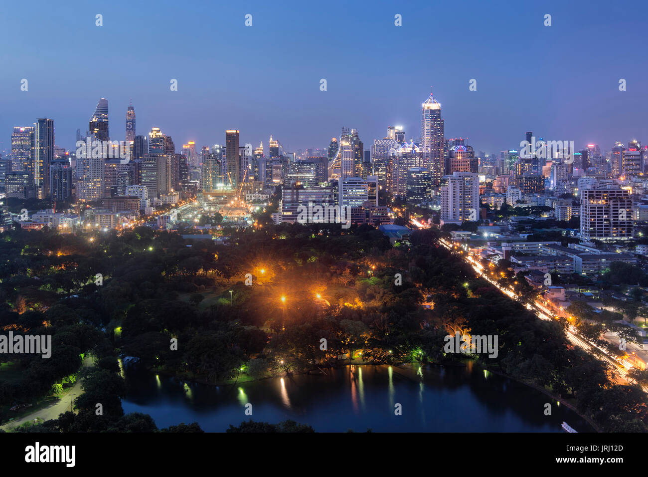 Bangkok Skyline and Lumpini Park, the biggest public park of Bangkok, Thailand. Lumpini Park is also referred to as Lungs of Bangkok. Stock Photo