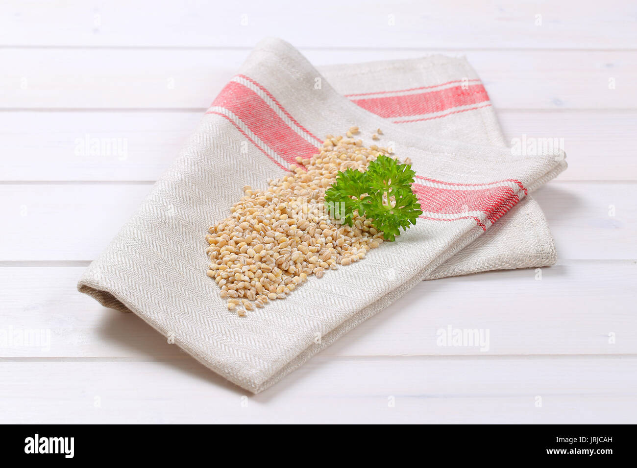 pile of pearl barley on folded place mat Stock Photo