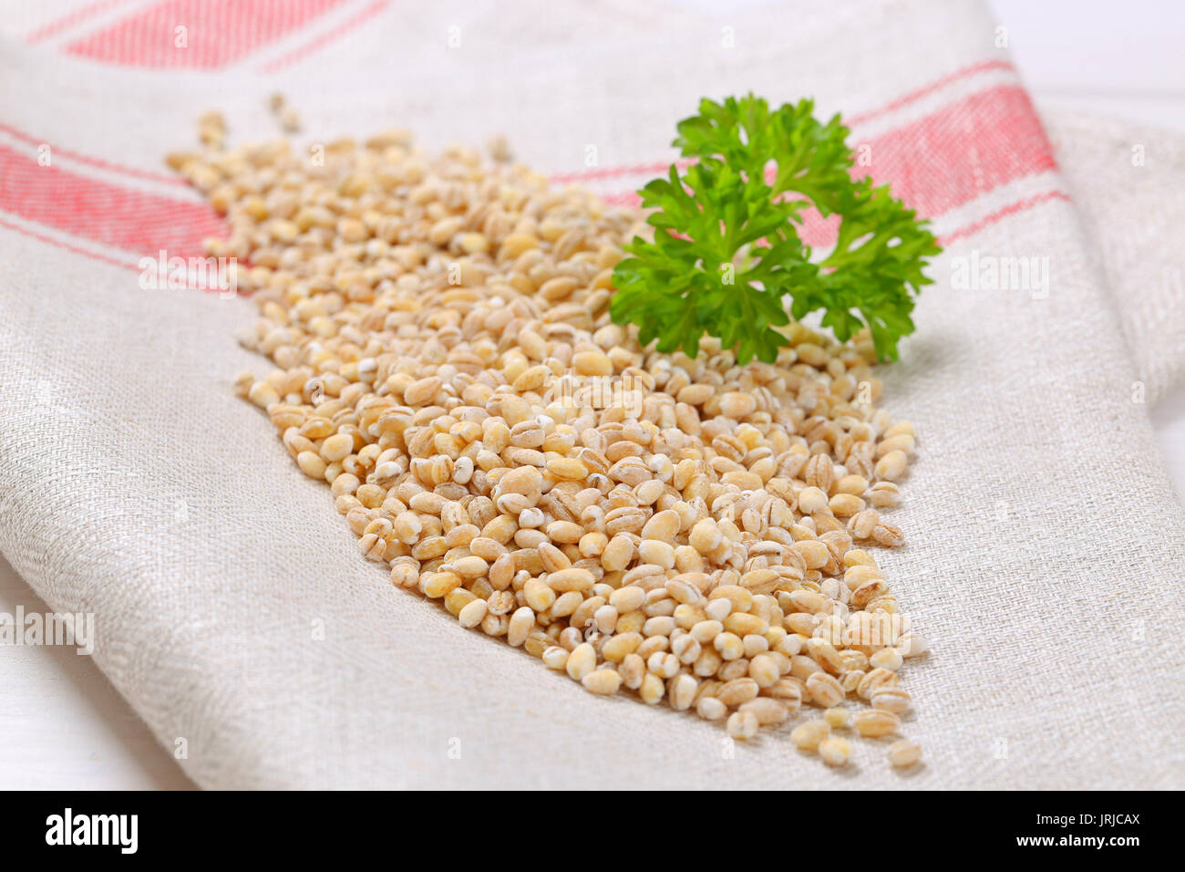 pile of pearl barley on folded place mat - close up Stock Photo