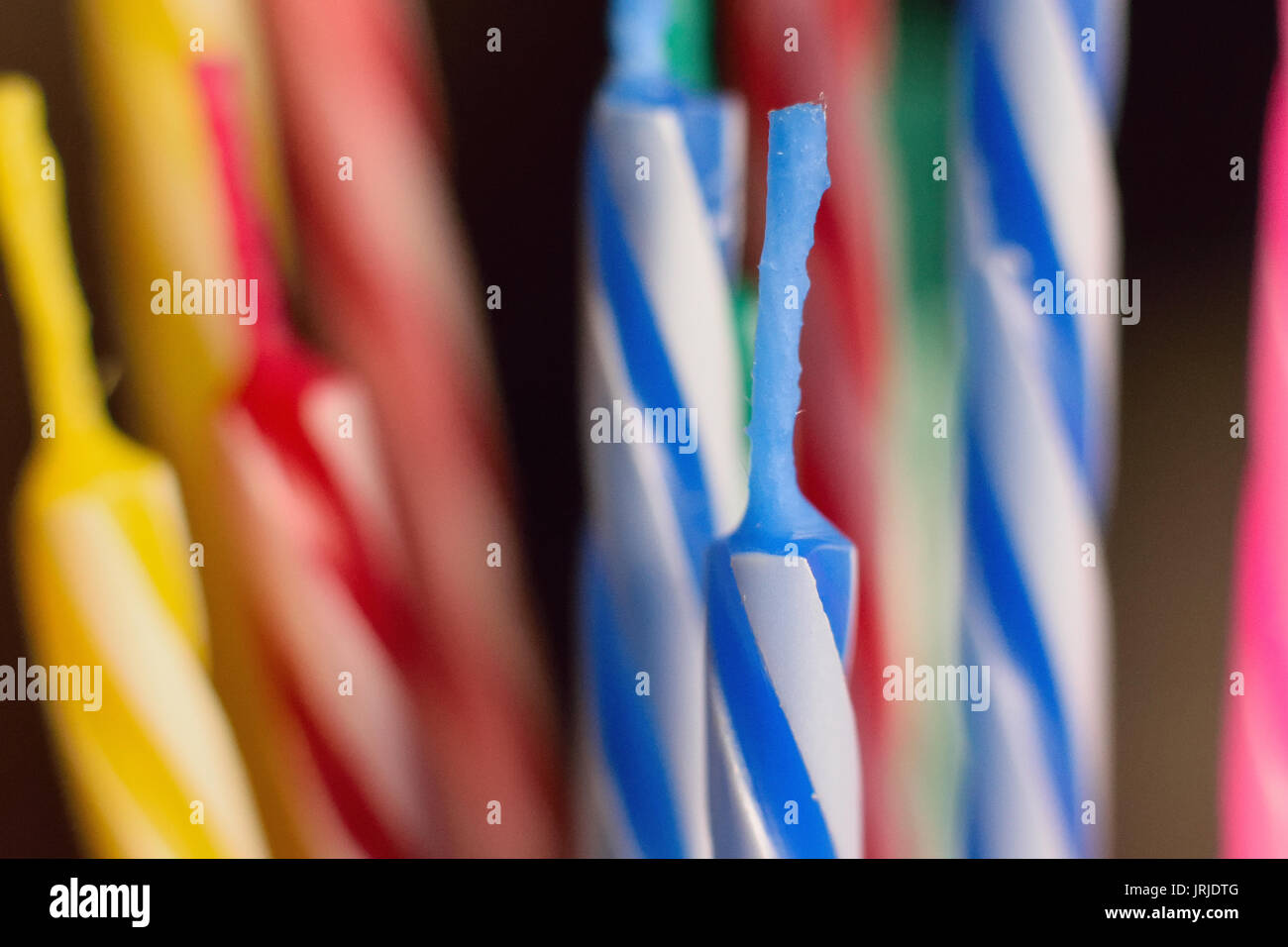 Macro background texture colorful lined up birthday cake candles Stock Photo