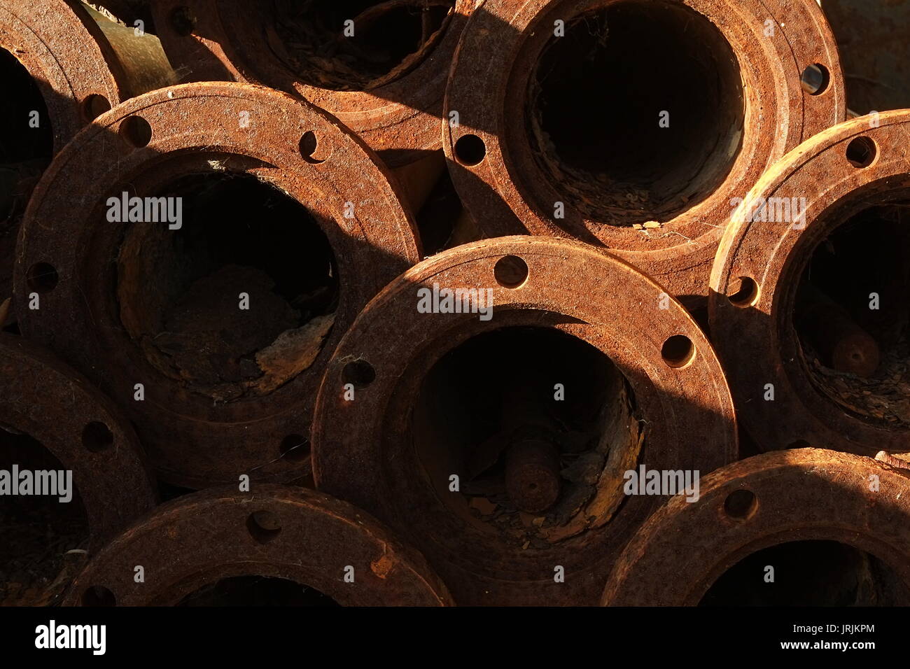 Stack of old and rusty industrial pipes Stock Photo