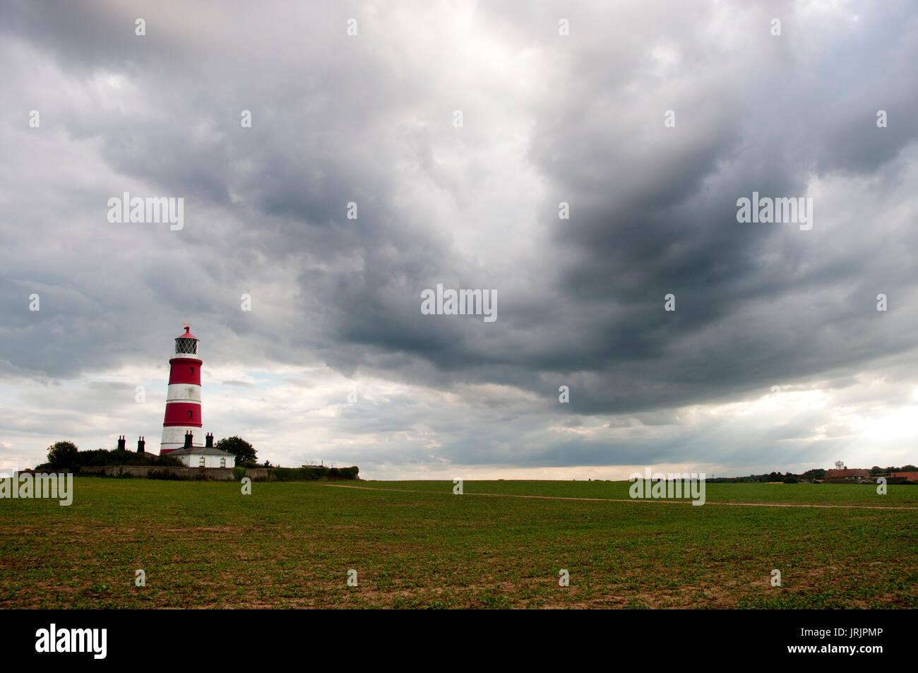 Happisburgh Lighthouse in Norfolk, England's oldest working lighthouse, on a cloudy day Stock