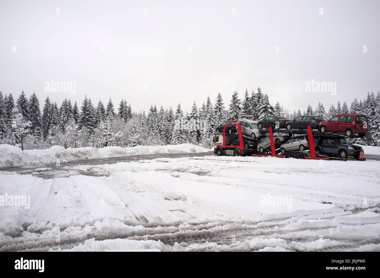 a red car truck in a snowy parking lot Stock Photo