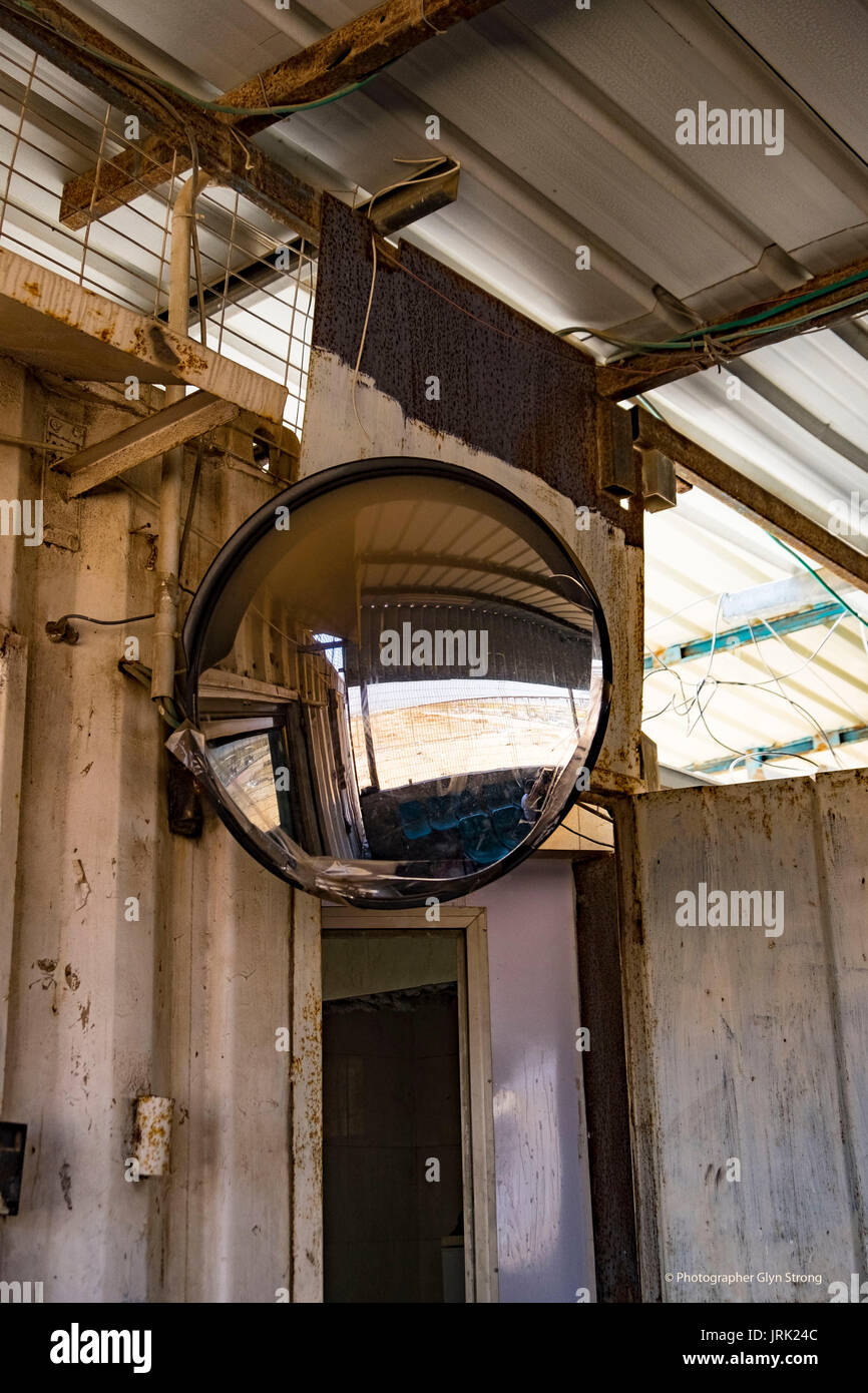 A mirror reflects the barren area separating the Israeli and Gaza checkpoints. For some Gazans it is the closest view they will get of Israel. Stock Photo