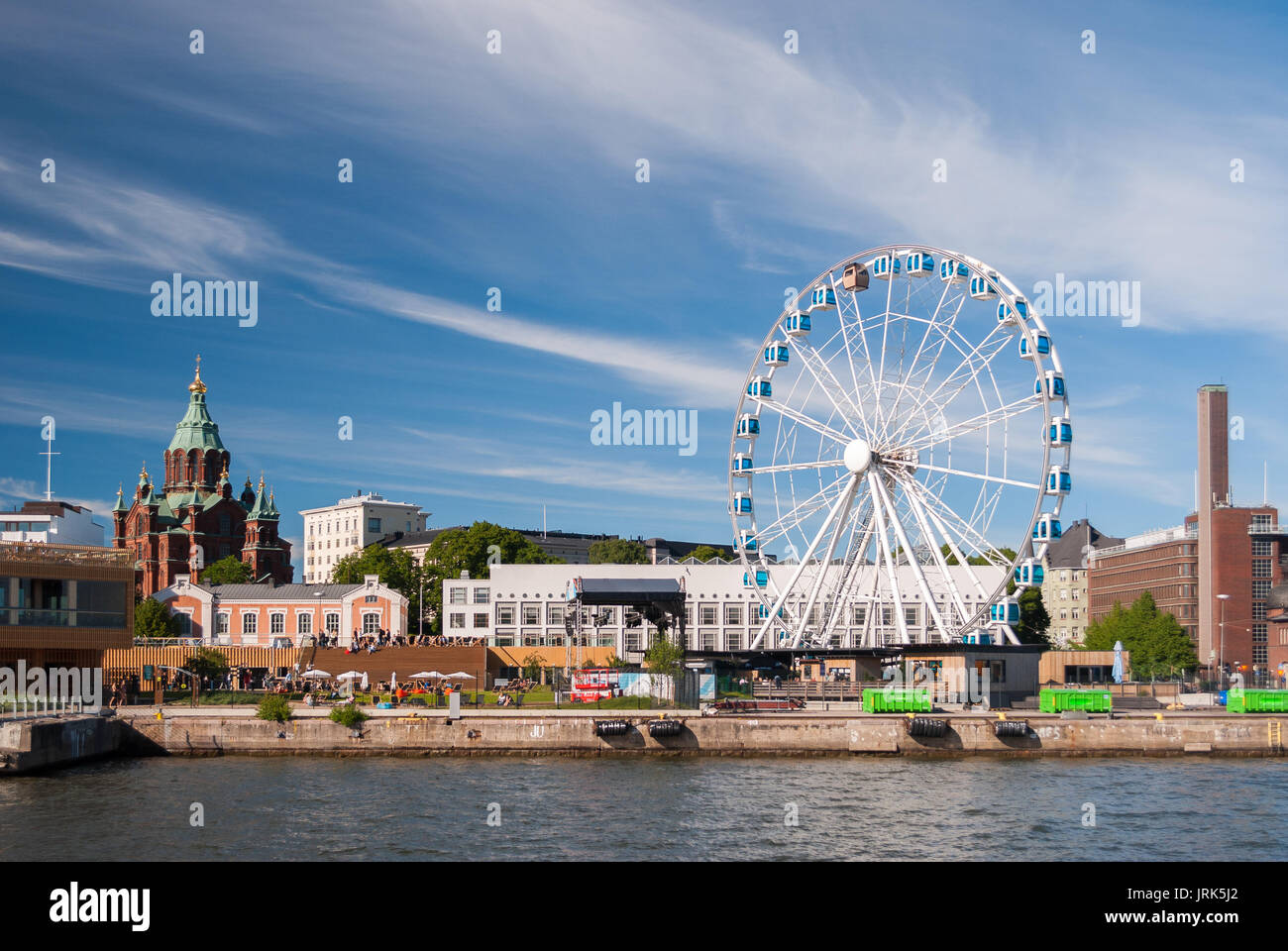 View of Helsinki harbor with Uspensky orthodox cathedral and a skywheel during a summer afternoon Stock Photo