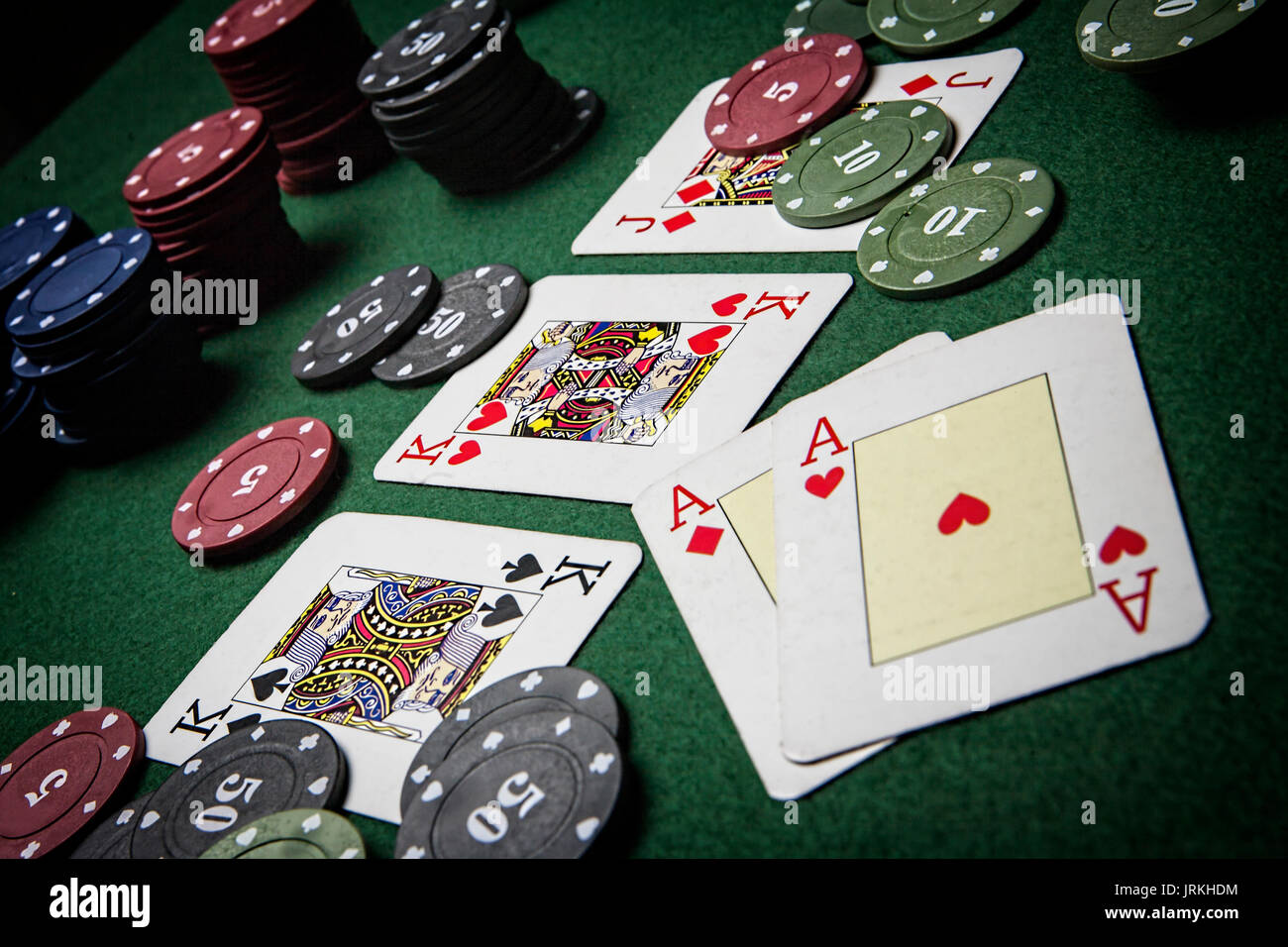 cards poker deck English, Poker game interesting with a possible winning combination on green background Stock Photo